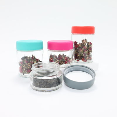 Contenedor de almacenamiento de dulces de flores de hierba de vidrio redondo liso con tapa de tornillo resistente a los niños