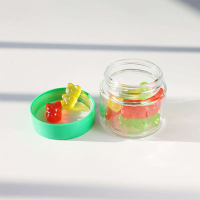 Contenedor de almacenamiento de dulces de flores de hierba de vidrio redondo liso con tapa de tornillo resistente a los niños